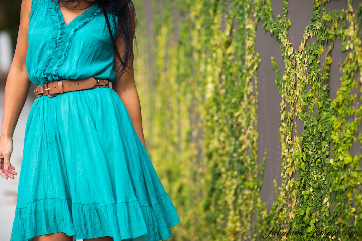 girl in front of wall in teal blue dress - skirt