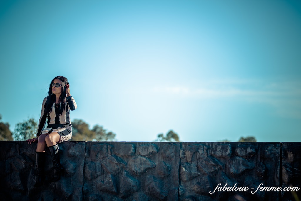 sitting on edge wall - fashion blogger in dangerous situation - silly