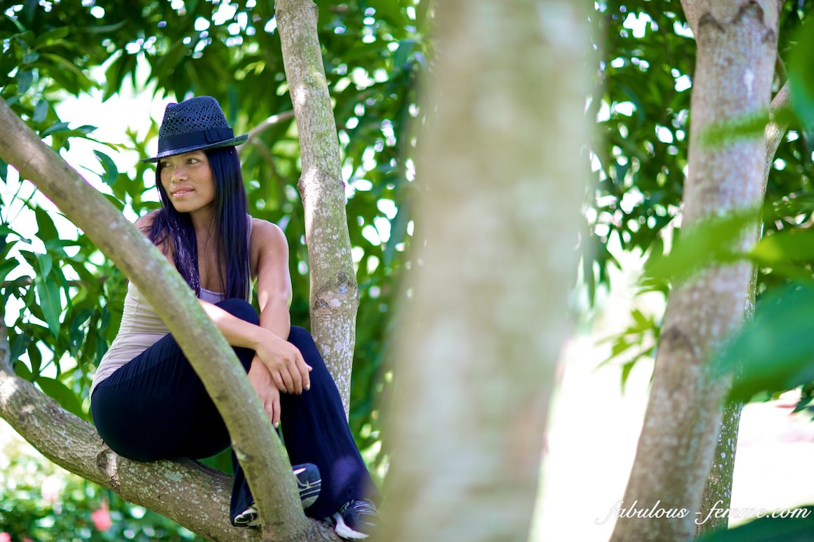 girl sitting in tree
