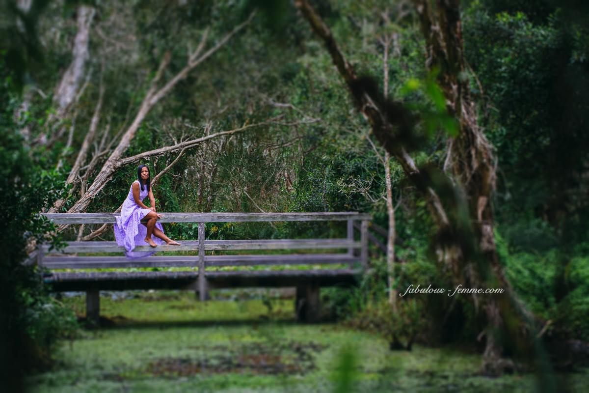 travel byron bay - girl on bridge in jungle in purple dress