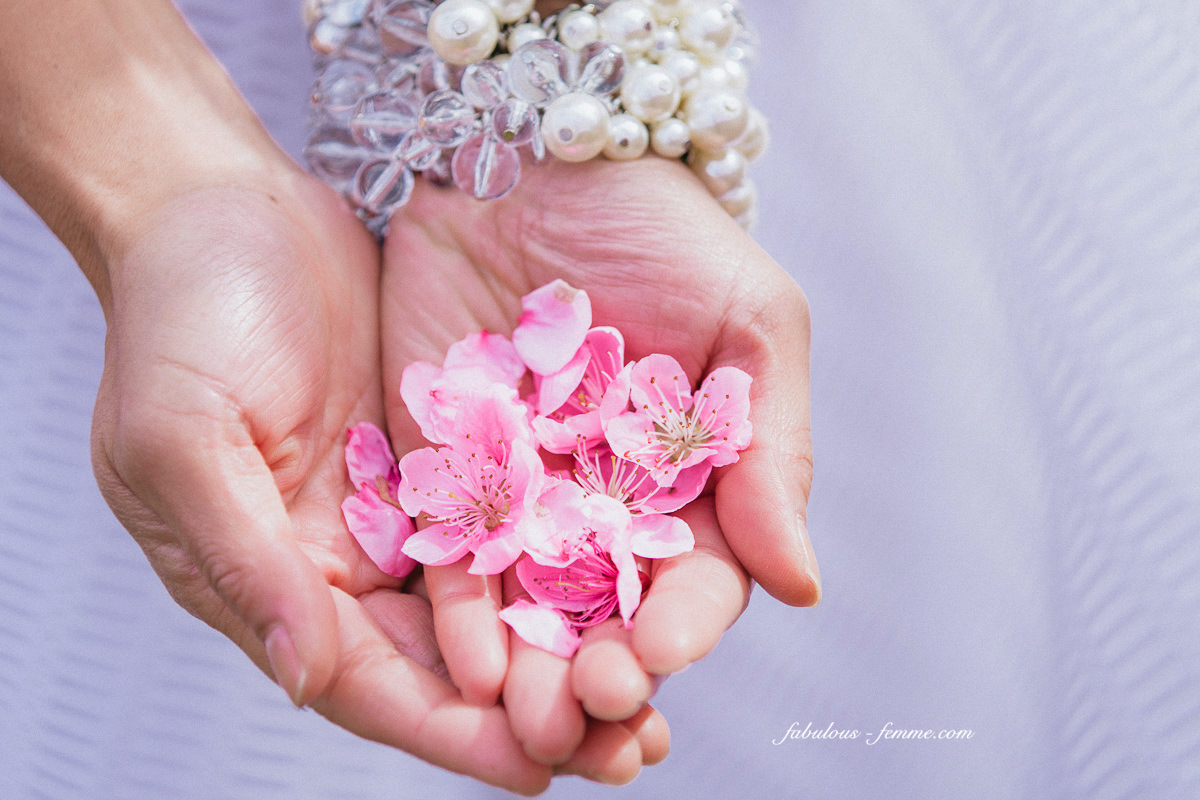 holding blossoms in hand