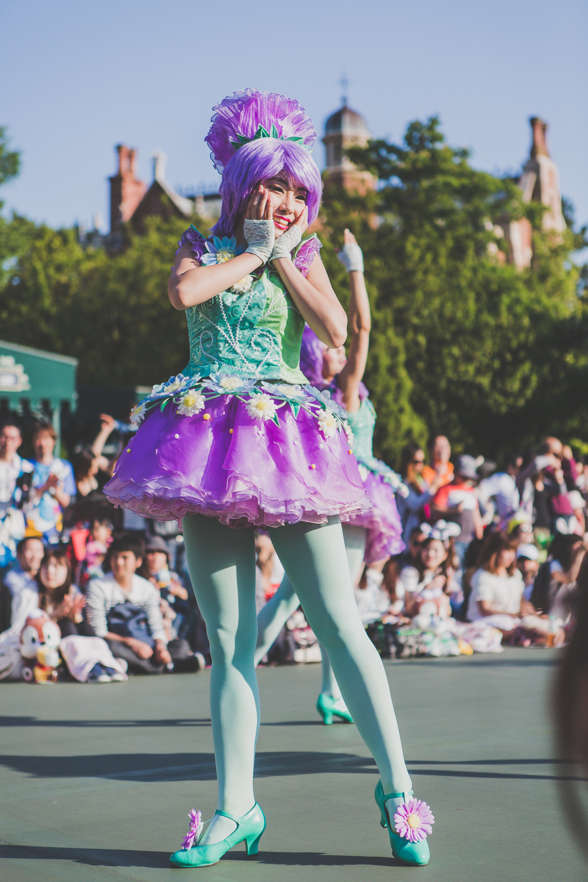 cute japanese girl in colourful outfit at disneyland