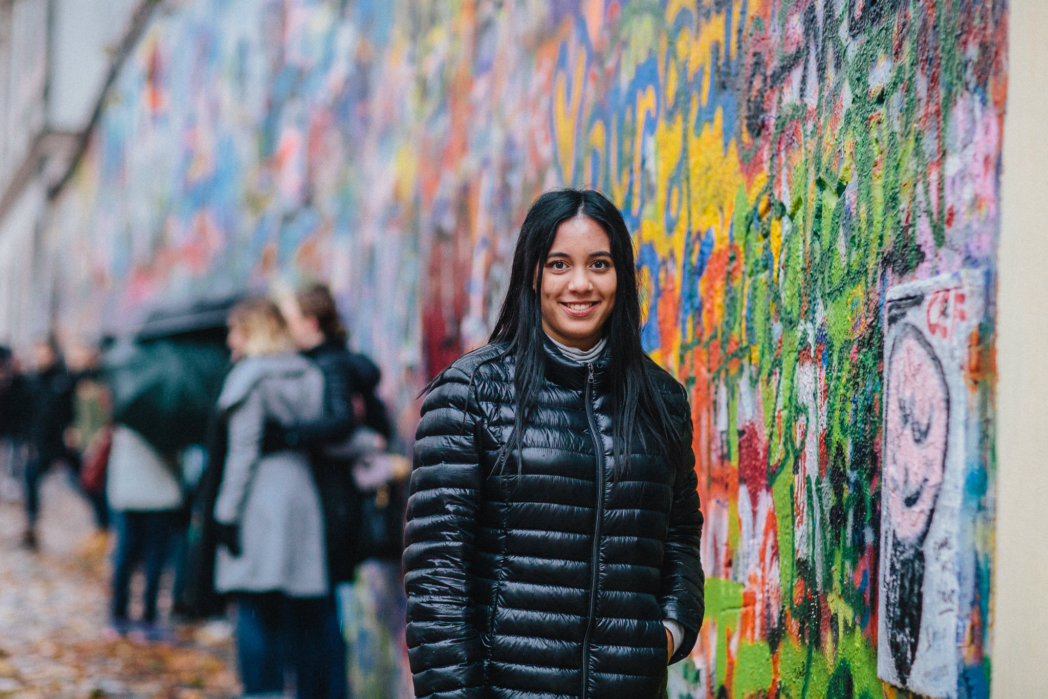 girl in front of street art wall