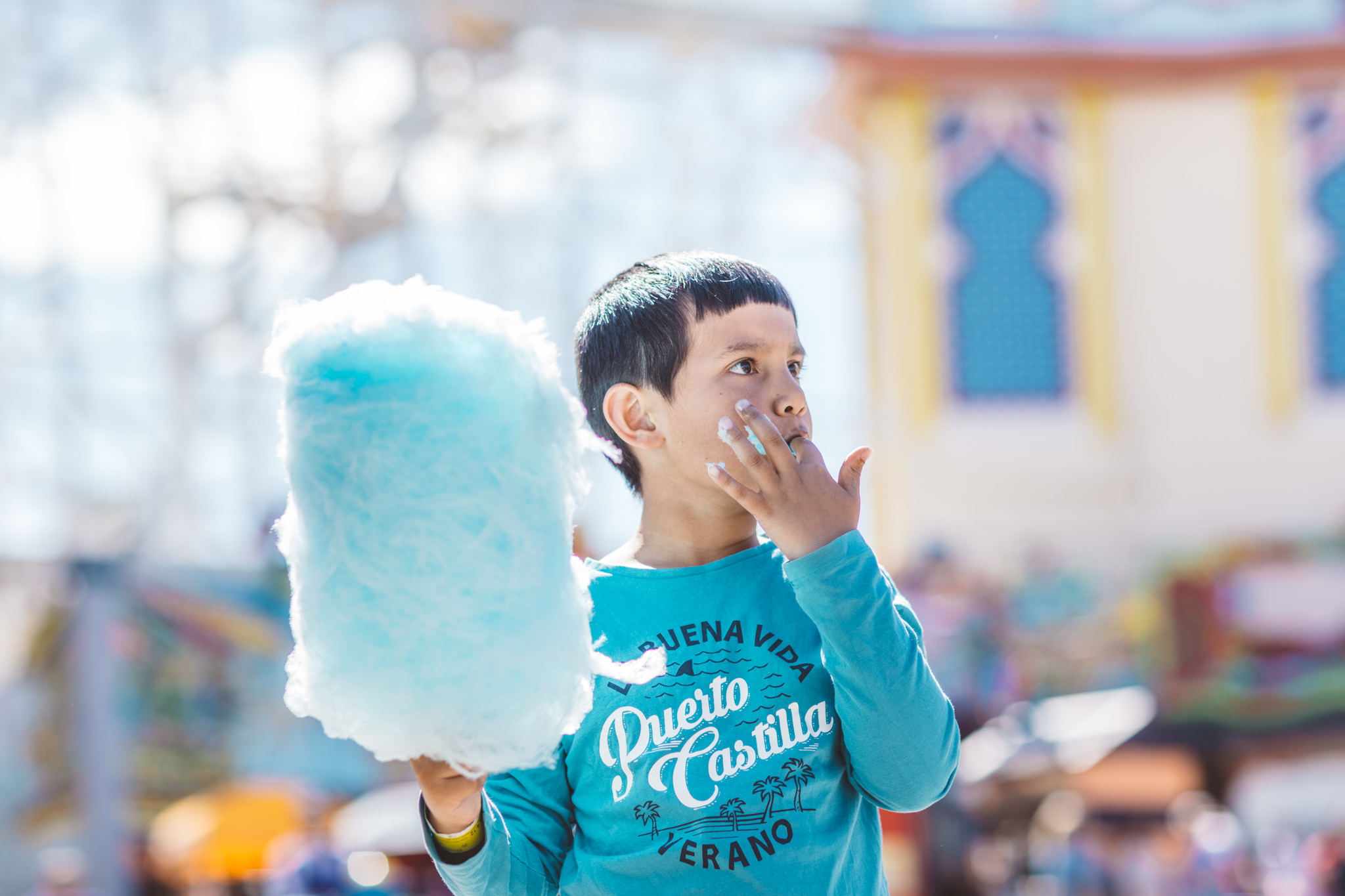 kid eating a big blue fairy floss